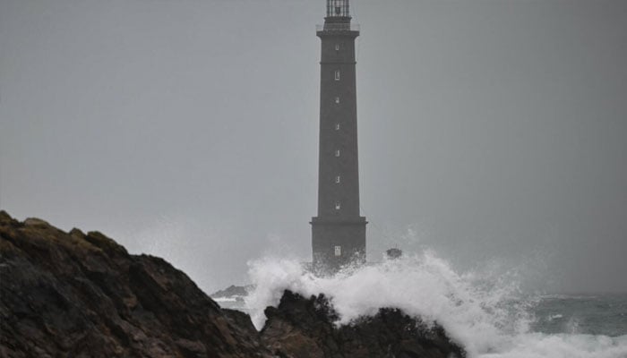 Waves hitting the lighthouse. —AFP/File