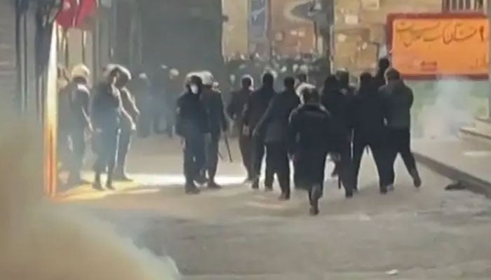 Screengrab of a UGC video posted on social media showing Iranian riot police dispersing protesters in Tehran on January 6, 2026.—AFP