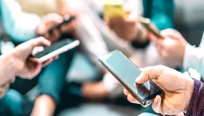 A representational image of people using mobile phones.—The News/File