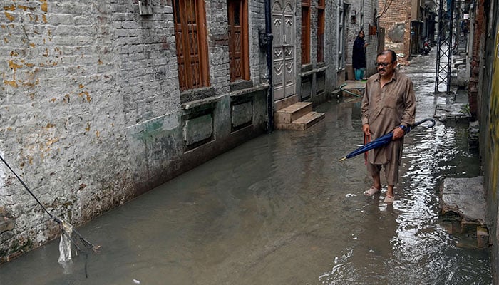 A man wades through a flooded street amidst heavy monsoon rains in Rawalpindi on July 17, 2025. — AFP
