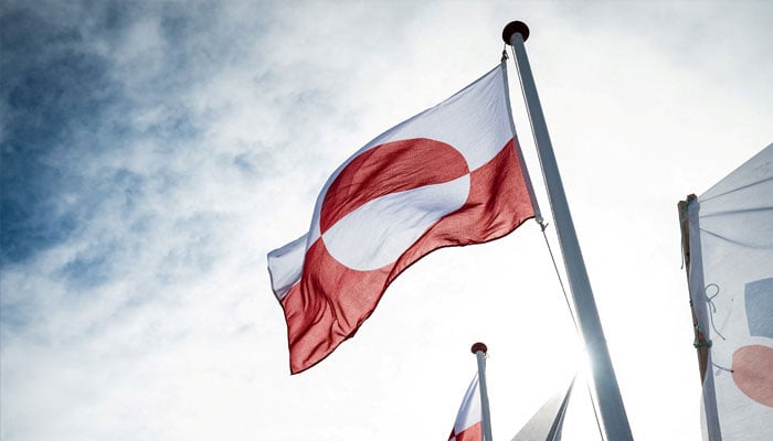 Greenlands flag flutters at the Inussivik hall in Nuuk, Greenland, April 6, 2021. — Reuters