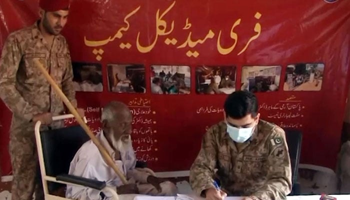 This representational image shows an army doctor examining a patient at a free medical camp. — Radio Pakistan/File