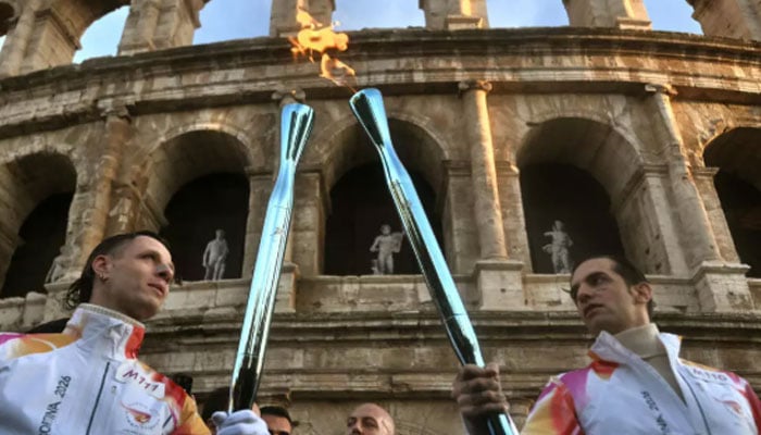 Singer Achille Lauro (right) and producer and DJ Edoardo Manozzi (aka Boss Doms) pass the torch at the Colosseum in Rome. —AFP/File