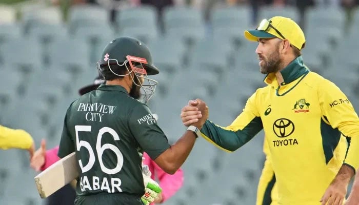 Representational image of Pakistans batter Babar Azam (left) shaking hand with an Australias Glenn Maxwell. — AFP/File