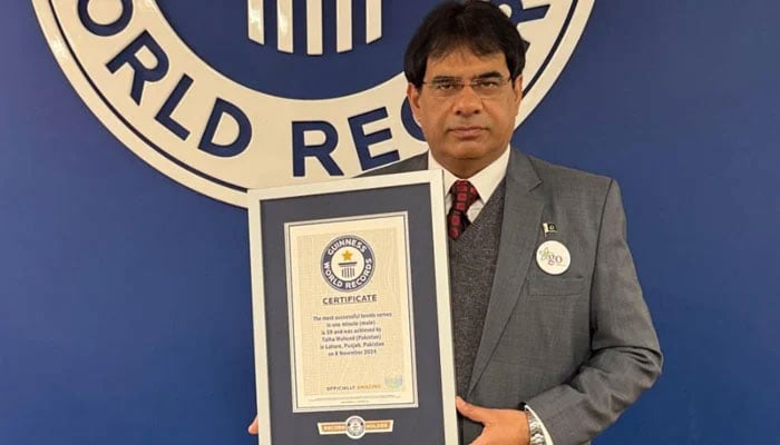 Pakistani senior tennis player Talha Waheed is seen with his Guinness World Record certificate for most serves in a minute. — Reporter