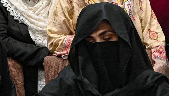 PTI founder Imran Khans wife Bushra Bibi signs a surety bond for bail in various cases at the registrar office at the Lahore High Court on July 17, 2023. — AFP