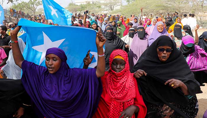 A woman carries the Somali national flag during a demonstration after Israel became the first country to formally recognise the self-declared Republic of Somaliland as an independent and sovereign state, a decision that could reshape regional dynamics and test Somalias longstanding opposition to secession, in Warta Nabada district of Mogadishu, Somalia, December 30, 2025. — Reuters