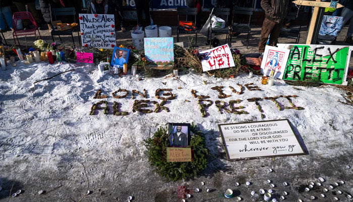 People gather during a vigil held by healthcare workers at a memorial for Alex Pretti on January 25, 2026 in Minneapolis, Minnesota. — AFP