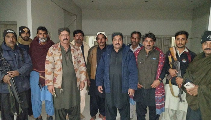 Criminals and policemen posing for photo released by Kamshmore police, January 26, 2026. —Facebook/Kashmore Police