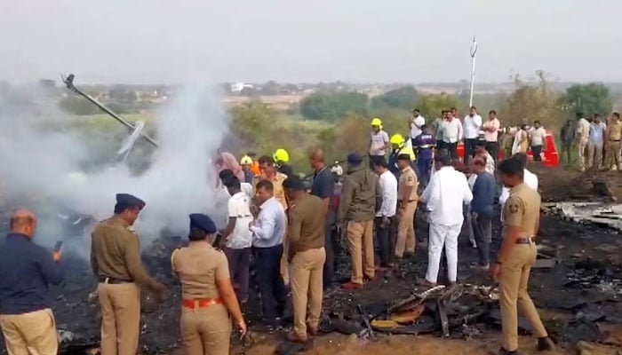 Emergency personnel and people gather next to smouldering wreckage at the site of a plane crash, in which Maharashtras Deputy Chief Minister Ajit Pawar and four others were killed, in Baramati, Maharashtra, India, on January 28, 2026. — Reuters