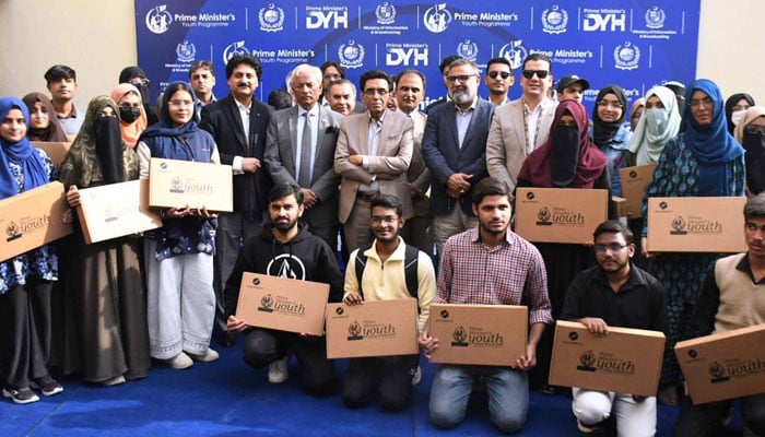 Federal Minister for Education and Professional Training and MQM Chairman Dr Khalid Maqbool Siddiqui poses for a group photo with students at the regional certificate and laptop distribution ceremony of the Prime Minister Laptop Scheme Phase IV at NED University of Engineering and Technology on January 29, 2026. — Facebook@AllAbout.MQM