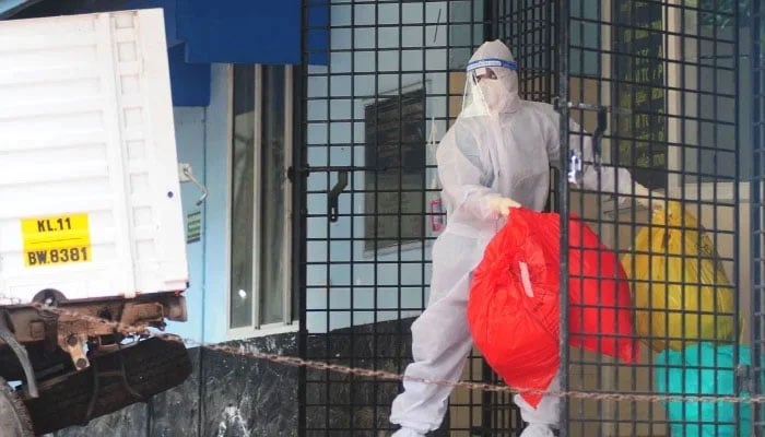 A health worker wearing protective gear disposes of biohazard waste from a Nipah virus isolation centre at a government hospital in Kozhikode, in Indias southern state of Kerala. — Reuters/File
