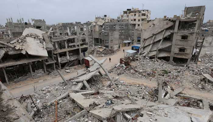 Palestinians walk surrounded by the rubble of houses destroyed in Israeli strikes during the war, in Khan Younis, southern Gaza Strip, January 22, 2026. — Reuters