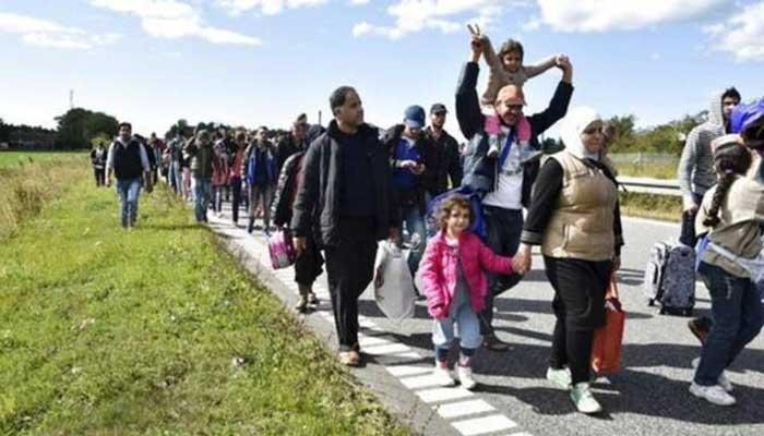 A large group of migrants, mainly from Syria, walk towards the north on a highway in Denmark on their way to Sweden.  — Reuters/File