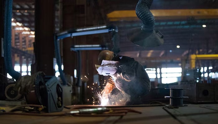 An employee works at a steel processing production line at a factory in Hefei, Anhui province, China, February 21, 2020.—Reuters