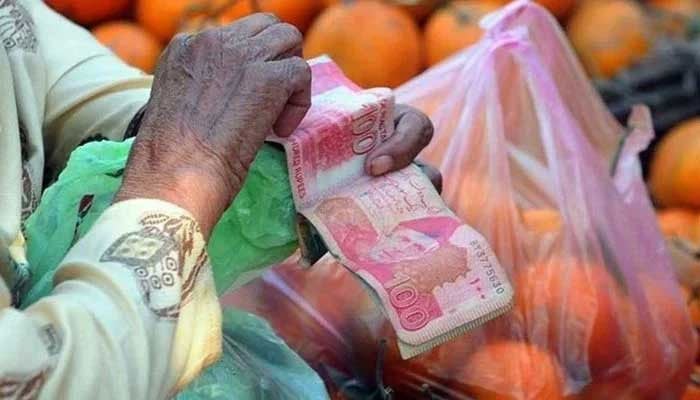 A person holding hundred-rupee notes. — AFP/File