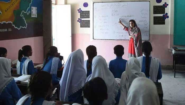 A teacher is taking a class at school. — AFP/File