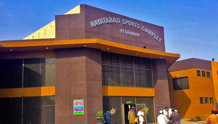 People standing outside Hayatabad Sports Complex building. —Facebook@HSCPeshawarOfficial/File