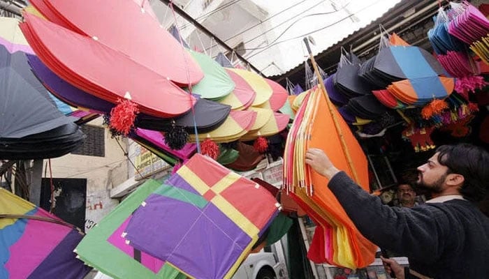 A shopkeeper displays kites at a kite market in Rawalpindi, near the capital Islamabad, February 28, 2005. — Reuters