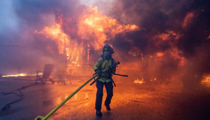 A firefighter battles the Palisades Fire as it burns during a windstorm on the west side of Los Angeles, California, US, January 7, 2025. — Reuters