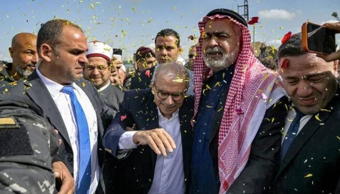 Lebanon’s Prime Minister Nawaf Salam being showered with confetti as he is received by locals during a tour in the heavily-damaged southern village of Dhayra near the border with Israel on Feb. 7, 2026. —AFP