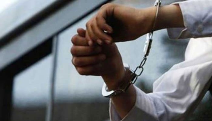 A representational photo of a person in handcuffs. — AFP/File