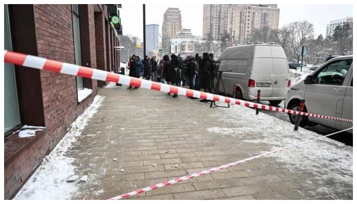 Media representatives gather in front of a high-rise residential building, the scene of an assassination attempt of Russian Lieutenant General Vladimir Alekseyev, in Moscow on February 6, 2026.—AFP