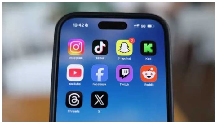 Instagram, TikTok, Snapchat, Kick, YouTube, Facebook, Twitch, Reddit, Threads and X applications are displayed on a mobile phone in this picture illustration. — Reuters/File