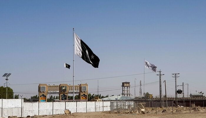 General view of the national flag and the Talibans flag in the background as seen from crossing point in the border town of Chaman. — Reuters/File