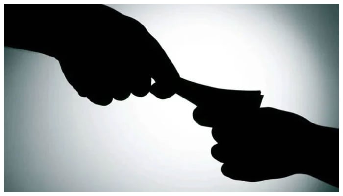 The representational image shows money being delivered as bribery. — AFP/File