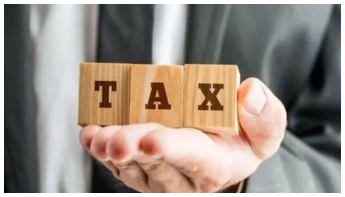 A representational image of tax shows wooden boxes with letters T, A and X written on them. — Reuters/File