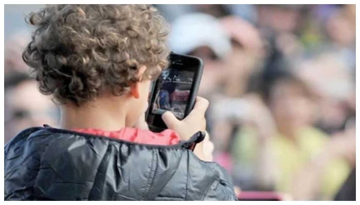 This photo taken on April 20, 2013 shows a child using a smartphone at Caulfield Racetrack in Melbourne. — AFP/File