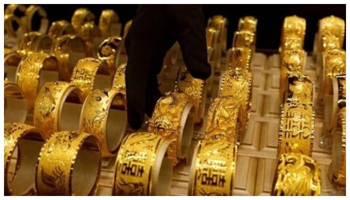 A salesperson arranges 24K gold bracelets for Chinese weddings at Chow Tai Fook Jewellery store in Hong Kong, China.— Reuters/File