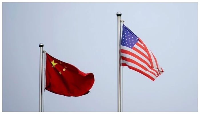 Chinese and US flags flutter outside a company building in Shanghai, China April 14, 2021. — Reuters