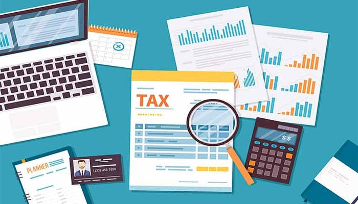 This representational image depicts a professional tax planning and financial auditing scene, featuring financial documents labeled TAX, a magnifying glass for analysis, graphs indicating financial data, and a calculator. — The News/File