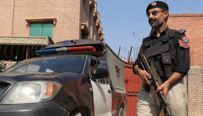 A Balochistan Police officer stands guard near his vehicle. — Reuters/File