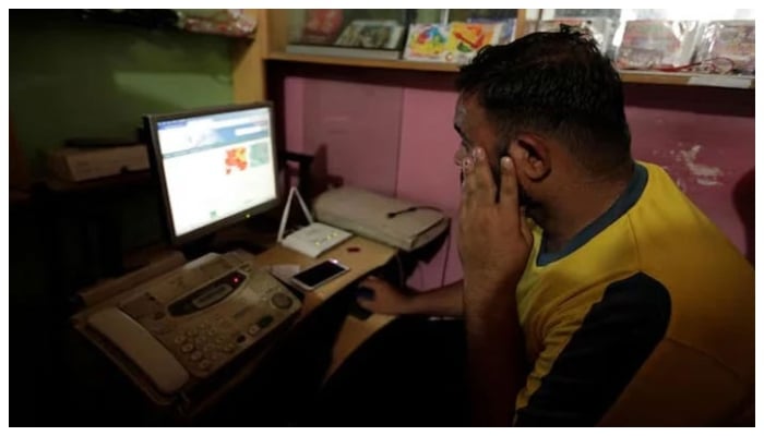 A man explores social media on a computer at an internet club in Islamabad. — Reuters/File