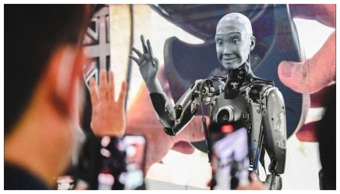 This representational picture shows a human-like robot waving at viewers. — AFP/File