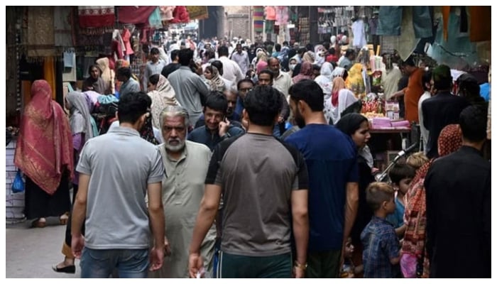 In this picture taken on April 16, 2023, people throng a market area in Lahore. — AFP