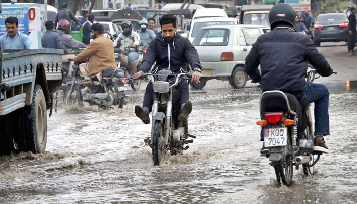 Vehicular traffic faces problems in movement due to stagnant water on the road after rain in different areas of the Provincial Capital on February 17, 2026. — APP