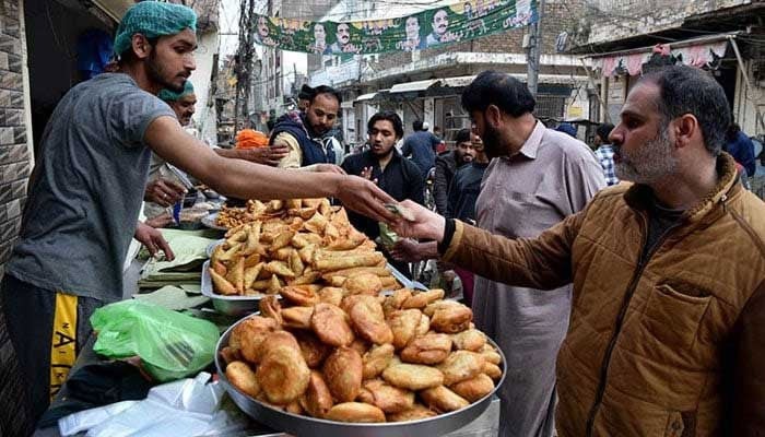 People are purchasing traditional food items in the city. — APP/File