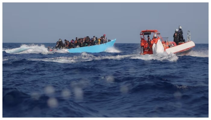 Migrants aboard an overcrowded boat are approached by the crew of the migrant search and rescue ship Sea-Watch 5, operated by the German NGO Sea-Watch, during a rescue operation in the Search and Rescue (SAR) zone in the central Mediterranean, off Libya, August 11, 2025.—Reuters