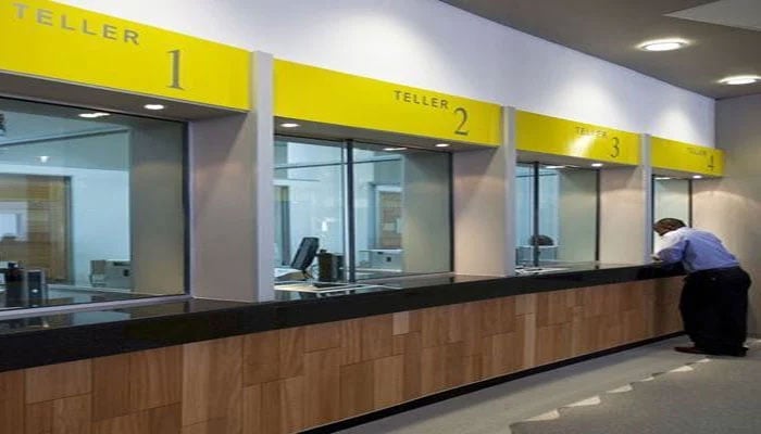 This image displays a modern bank interior design featuring a service counter area.  — The News/File