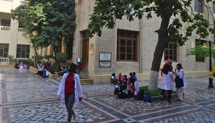 Students gather at a yard of the Dow University of Health Sciences in Karachi on January 13, 2022. — AFP