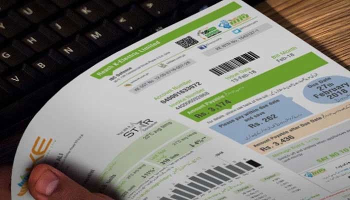The representational image shows a person holding an electricity bill in their hand. — KE/File