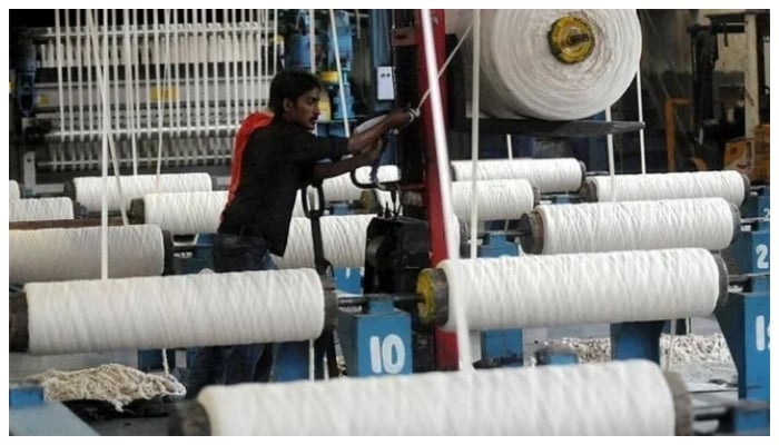 An employee works at a textile factory in Karachi. — AFP/File