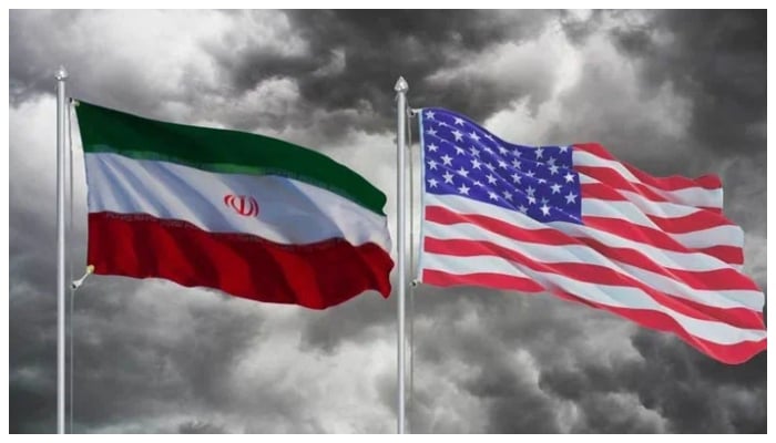 Iran and US flags fluttering in the air. —TheNews/File