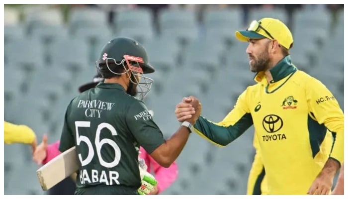 Representational image of Pakistans batter Babar Azam (left) shaking hand with an Australias Glenn Maxwell. — AFP/File