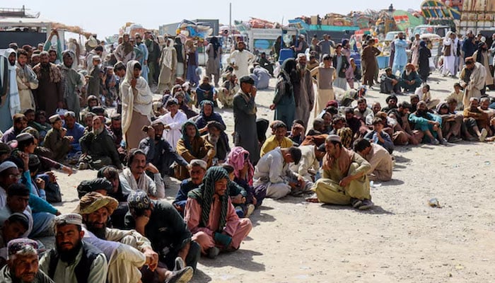 Afghan citizens wait to register as they attempt to return to their country, with trucks loaded with their belongings seen in the background, at the Chaman border on October 18, 2025. — Reuters