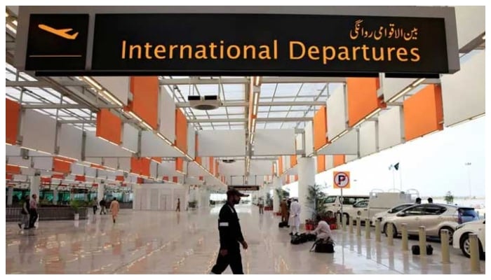 An airport staffer walks past the entrance of international departures at the Islamabad airport. — Reuters/File